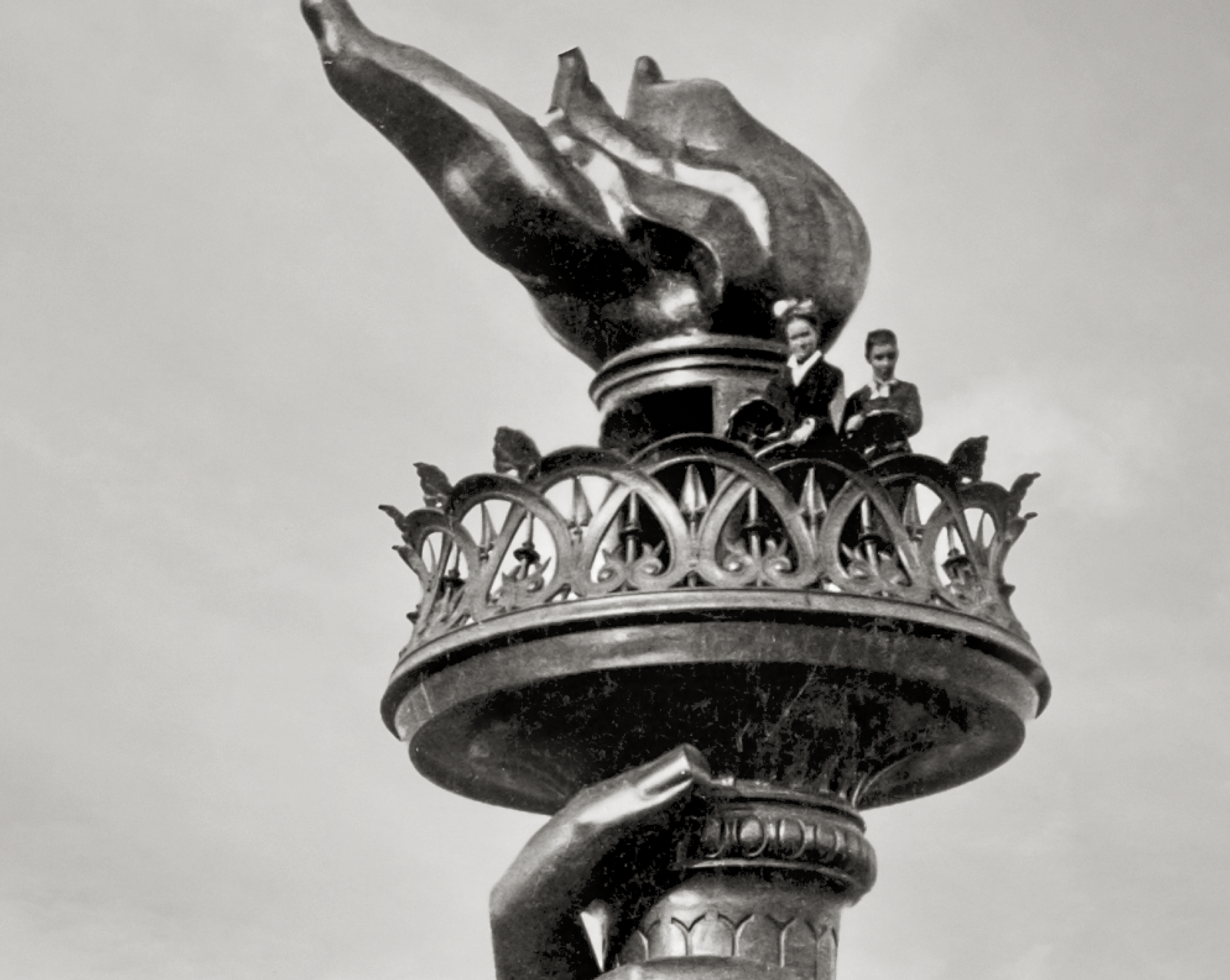 Two woman are standing at the top of the flame.
