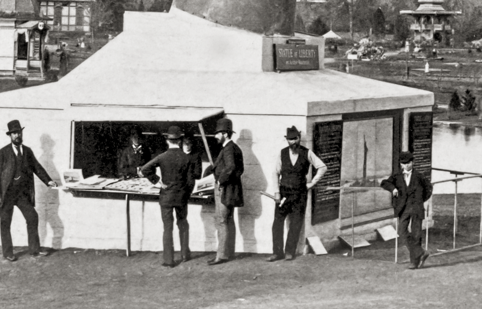 Men at the bottom of the flame in a tent buying tickets to go up to the top of the flame.