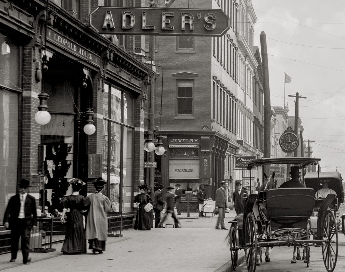 A closeup of Adler&#39;s store with women walking by.