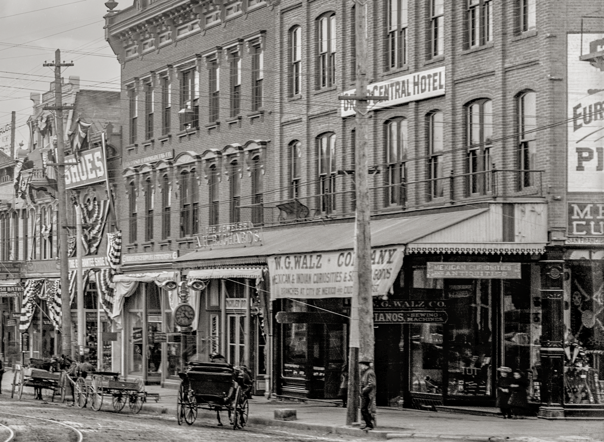 Close up of a store with a horse and carriage in  front.